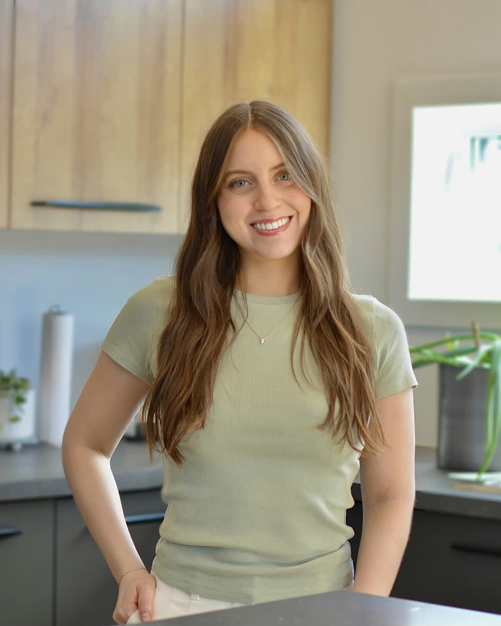 Martina, Registered Dietitian-Nutritionist, standing in her bright kitchen