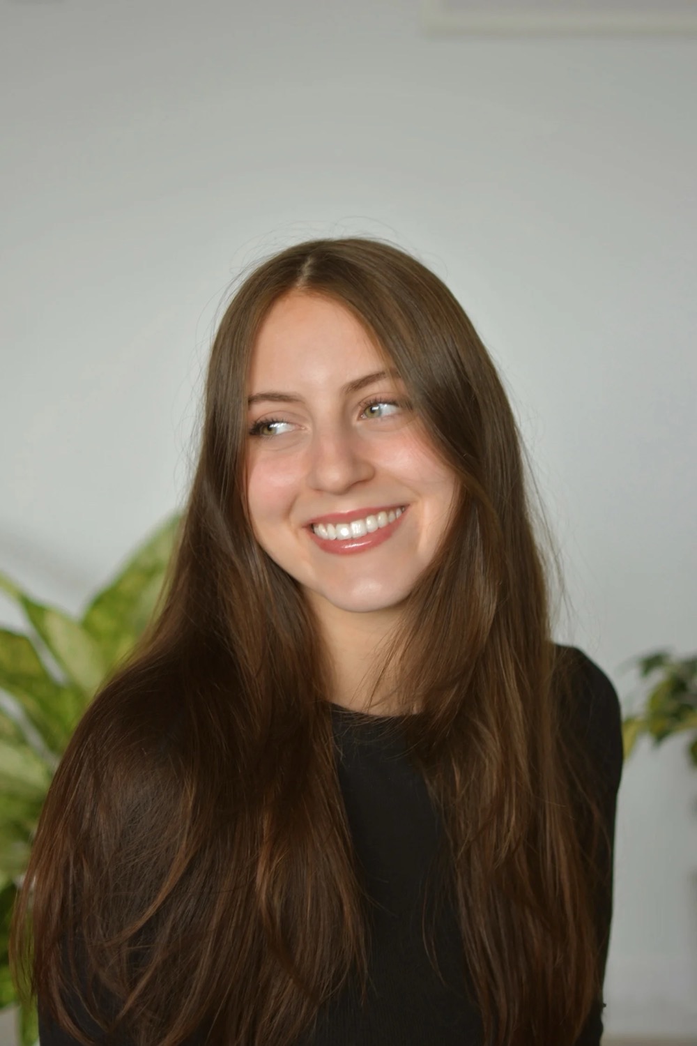 Martina-Grace De Bonis, Registered Dietitian-Nutritionist, smiling in front of green plants