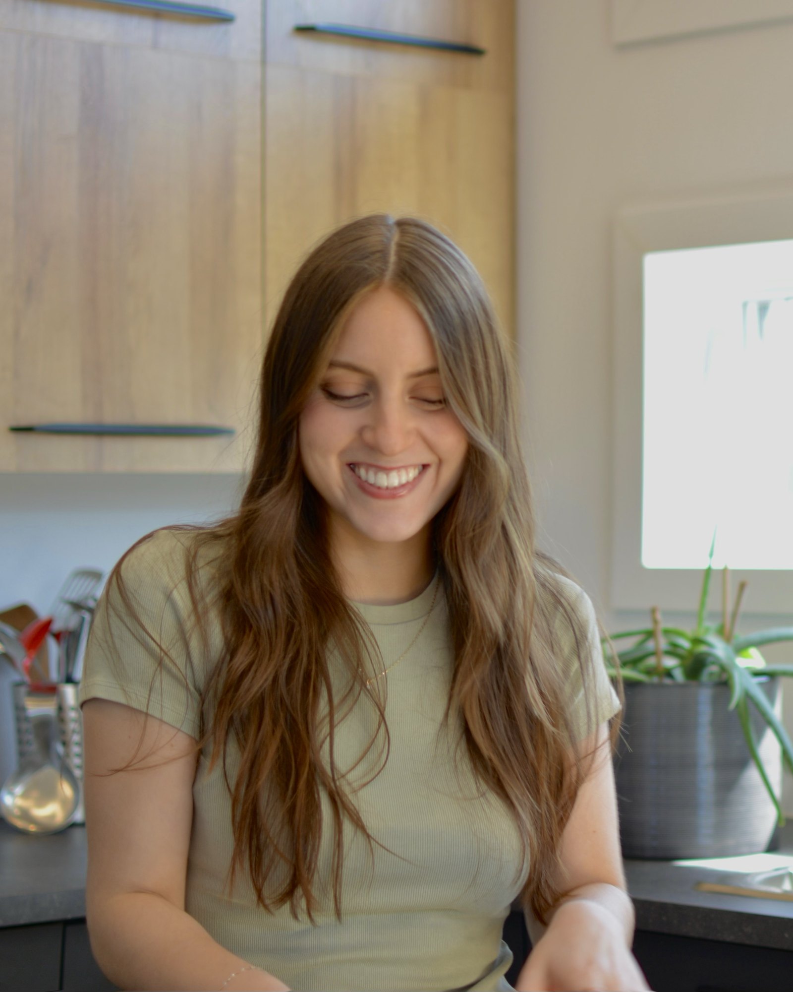 Martina smiling in her kitchen